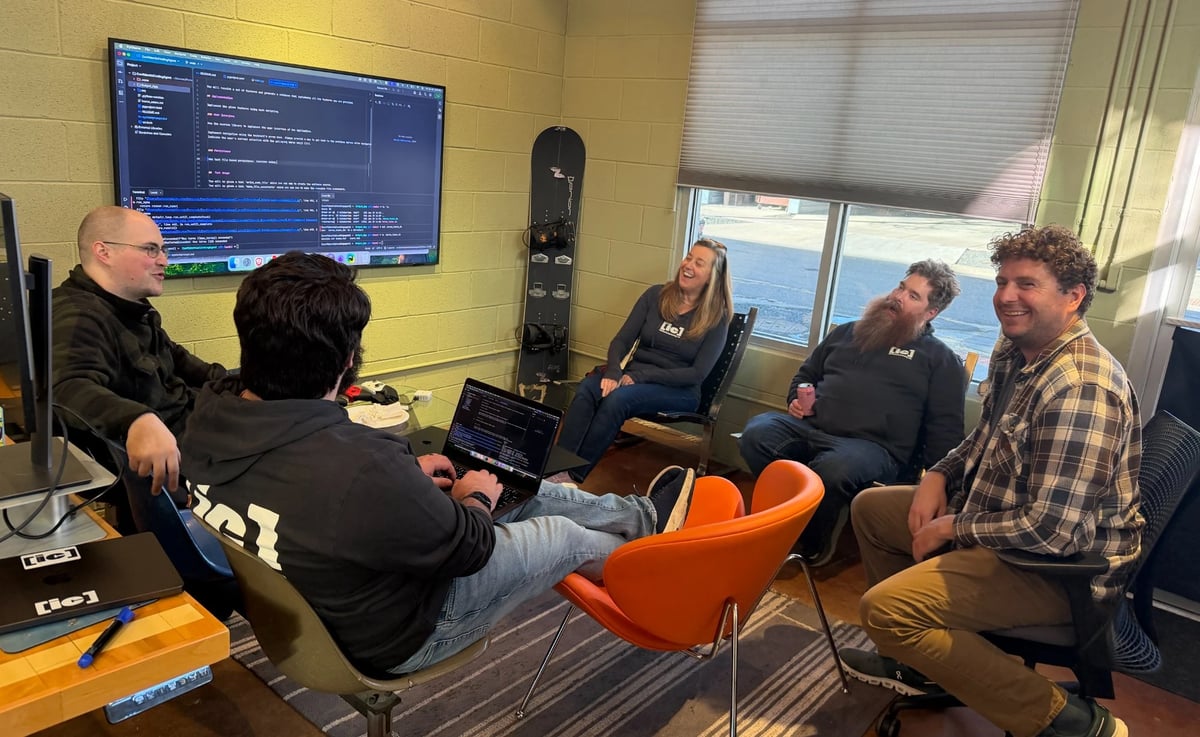 a group of developers talking and writing code